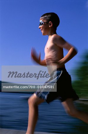 Boy in Swimwear, Running on Dock Wearing Goggles