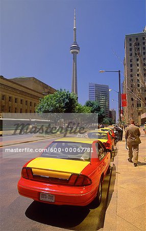 Row of Taxis Parked on Street, With CN Tower in Distance, Toronto, Ontario, Canada