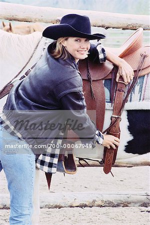 Portrait of Woman Adjusting Saddle