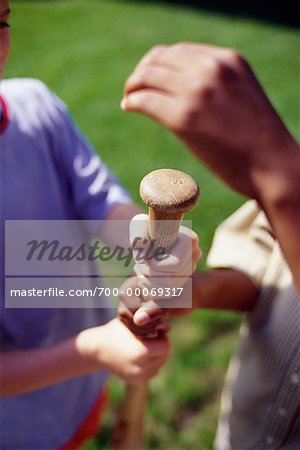 Close-Up of Children's Hands on Baseball Bat