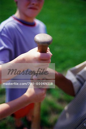 Close-Up of Children Holding Baseball Bat