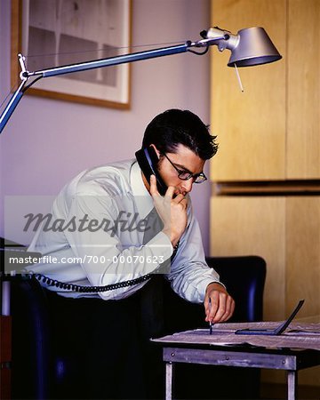 Businessman Using Phone, Reading Newspaper