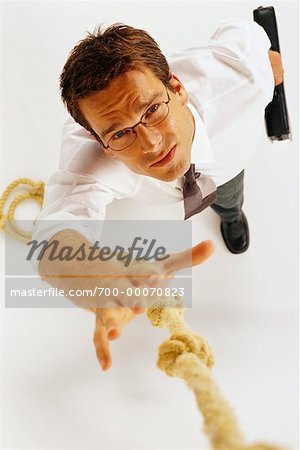 Overhead View of Businessman Trying to Grab Rope
