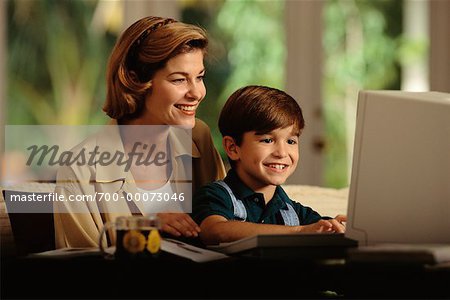 Mother and Son Using Computer Smiling