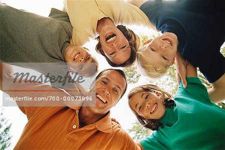 Portrait of Family Huddled Together Outdoors