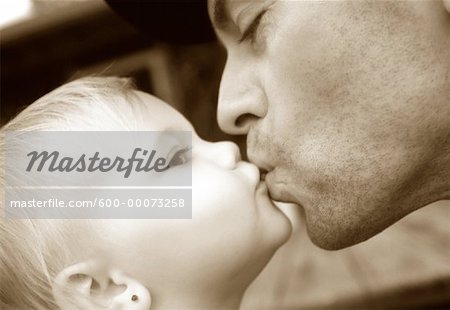 Close-Up of Father Kissing Baby