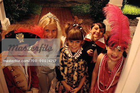 Group Portrait of Children Standing in Doorway Wearing Halloween Costumes