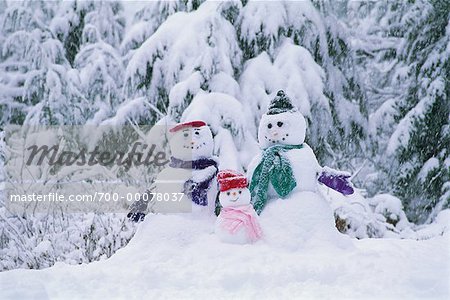 Famille bonhomme de neige et neige couvertes d'arbres