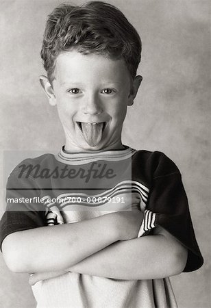 Portrait of Boy with Arms Crossed Sticking Tongue Out