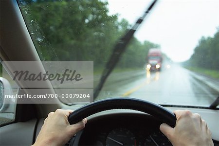 Driver's Perspective in Car on Road with Transport Truck in Rain