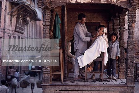 Barber Shaving Customer in Shop Under Portico Bhaktapur, Kathmandu, Nepal