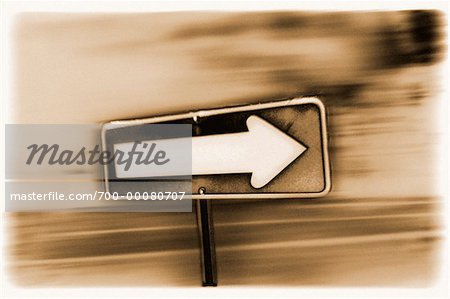 One Way Sign and Blurred Road