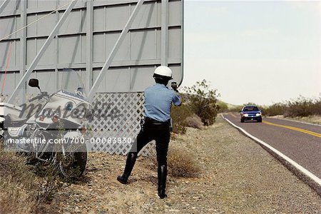 Police Officer with Motorcycle at Radar Trap