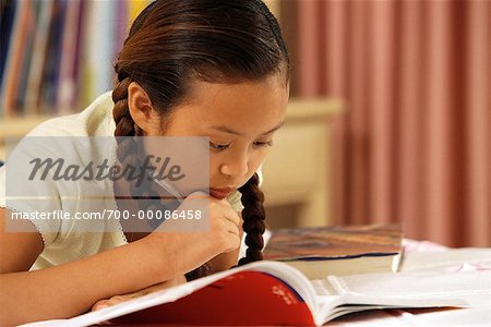 Girl Lying on Bed, Reading Book