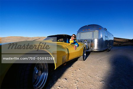 Woman With Sportscar and Trailer in the Desert