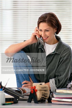 Woman Using Phone at Desk