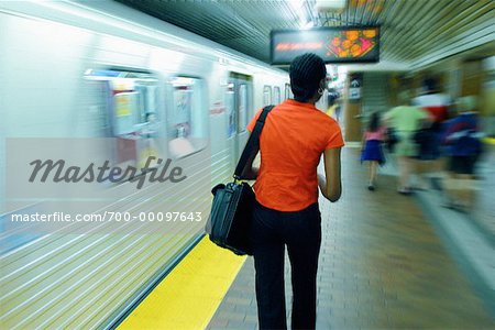 Woman Walking on Subway Platform