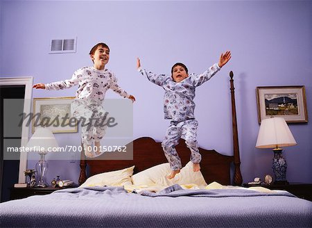 Children Jumping on Bed