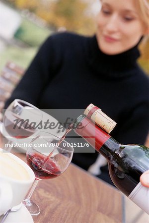Wine Being Poured At A Cafe For A Woman