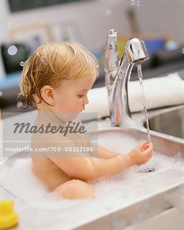 Baby Bathing In Kitchen Sink
