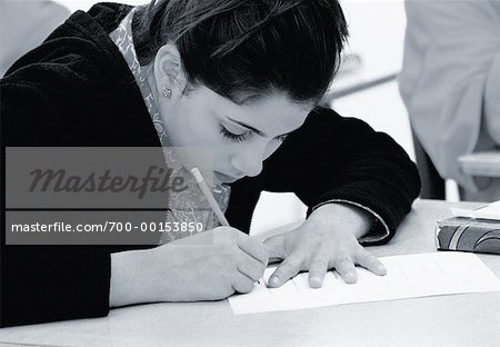 Girl Writing in Classroom