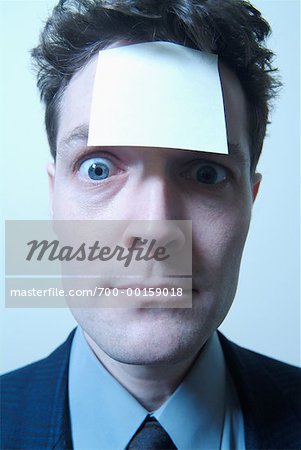 Businessman with Sticky Note On Forehead