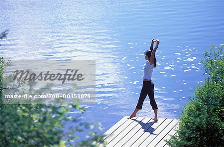 Woman Stretching on Dock