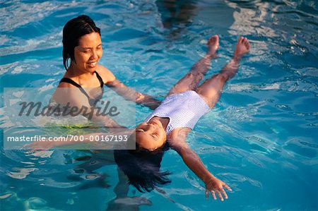 Woman Teaching Girl to Swim