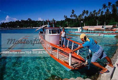 Fishermen Pushing Boat from Harbour Davao, Mindanao, Philippines