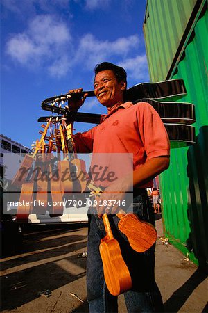 Man Selling Guitars and Ukuleles Cebu Port, Cebu City Philippines Man Selling Guitars and Ukuleles Cebu Port, Cebu City Philippines