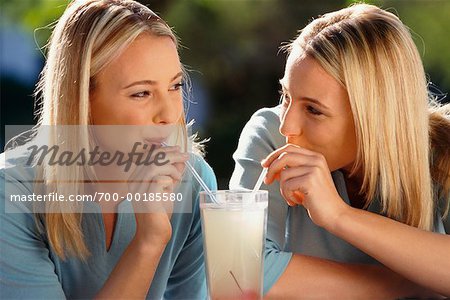 Twin Sisters Sharing a Drink