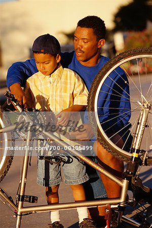 Father and Son Fixing Bicycle