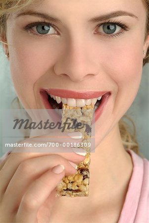 Woman Eating Granola Bar