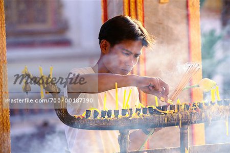 Boy Lighting Incense Wat Chalong Temple Phuket, Thailand