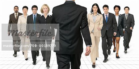Businessman Walking Towards Group of Business People