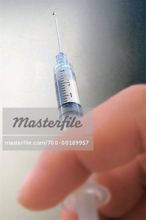 Person Holding a Hypodermic Needle