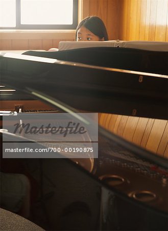 Girl Sitting Behind Piano