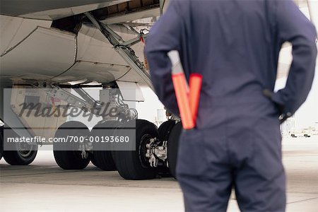 Airline Worker Looking at Airplane