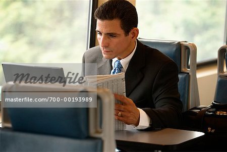 Homme d'affaires avec ordinateur portable et le journal sur le Train