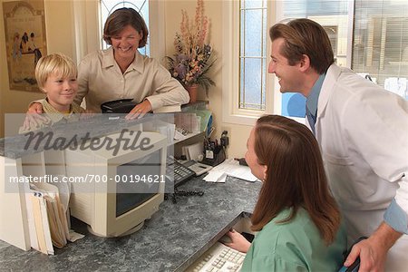 Mother and Son at Dentist Reception Desk