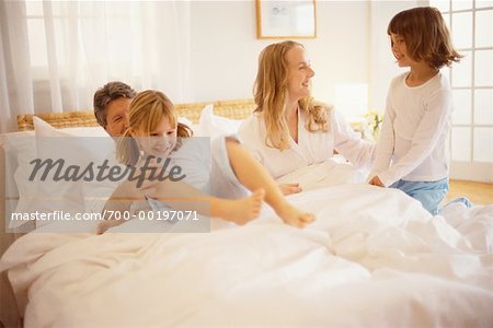 Family Playing in Bed