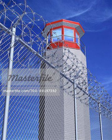 Prison Tower behind Barbed Wire