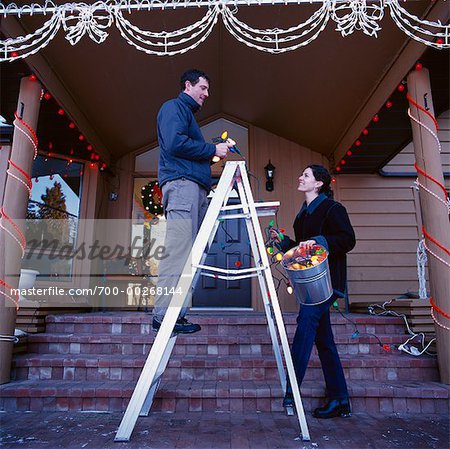 Couple Putting up Christmas Lights