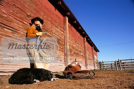 Woman Holding Lasso and Dog Lying On Ground
