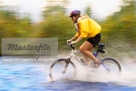 Woman Crossing River on Mountain Bike