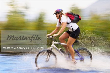 Woman Crossing River on Mountain Bike