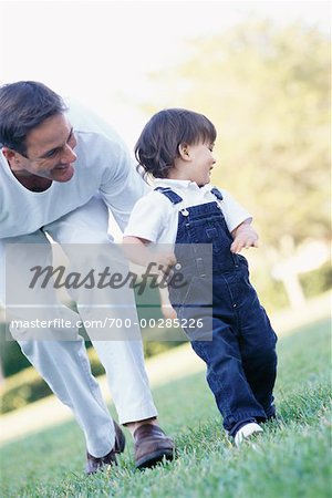 Boy Learning to Walk with Father