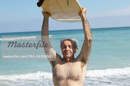 Man Holding Surf Board