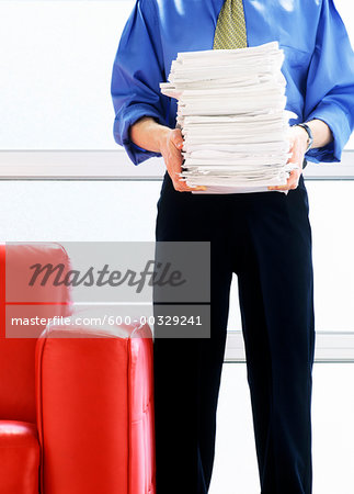 Man holding a Stack of Papers