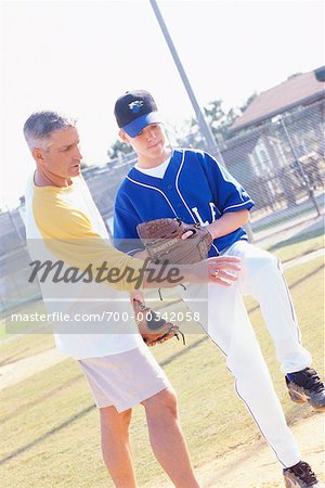 Man Coaching Boy with Pitching